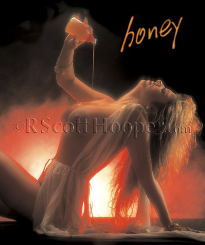 Photo of topless woman pouring honey on her body