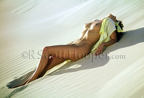 Photo of nude woman in sand dunes