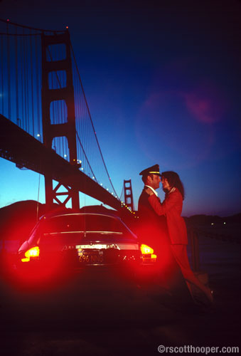 Photo of couple by the Golden Gate bridge at sunset