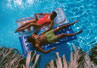 Image of couple on rafts in pool