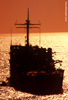 Image of large ship in the ocean at sunset